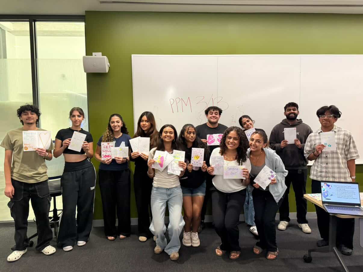 Project Pulmonary students holding handwritten encouragement cards in a classroom